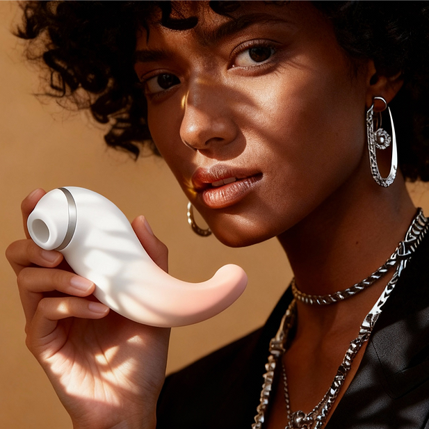 Model holding Zenzooone Luna suction vibrator made of body safe silicone